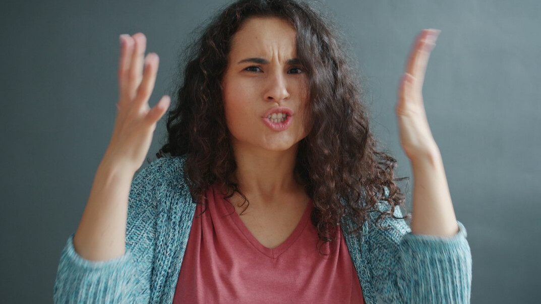 Woman speaking confidently while gesturing with her hands