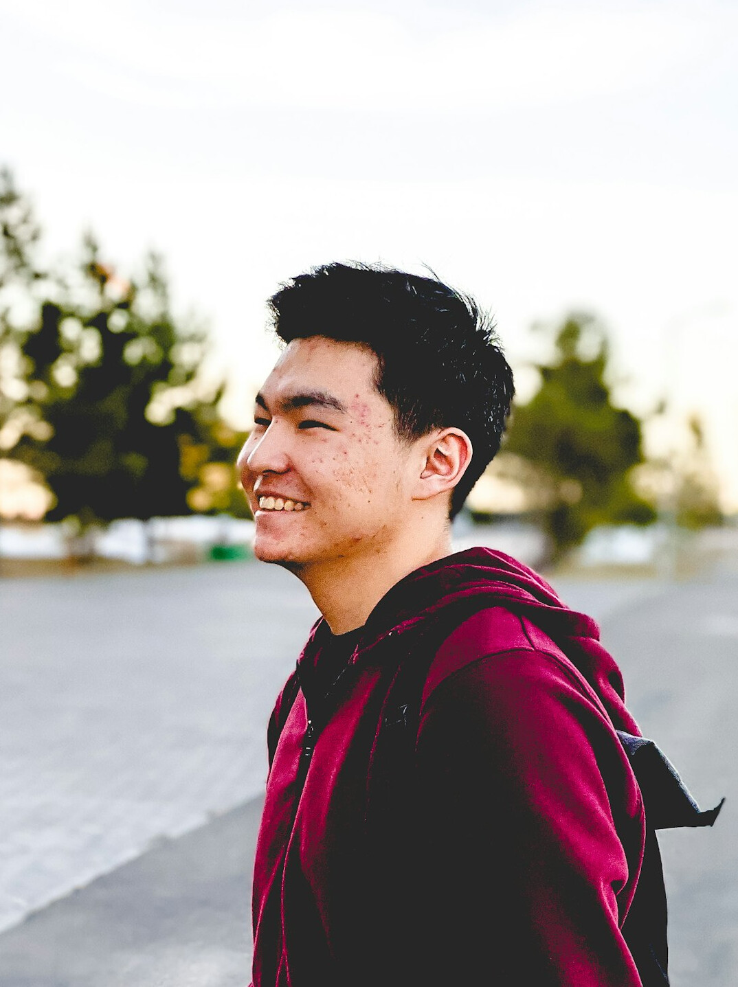 Young man smiling calmly while looking to the side